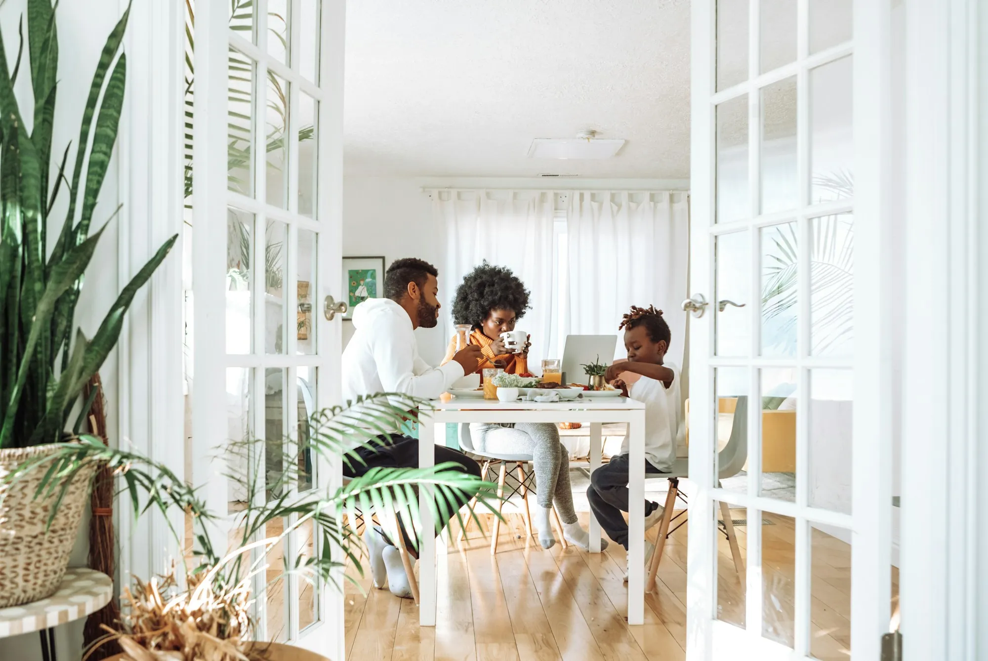 Family sitting around a dining table in a bright room